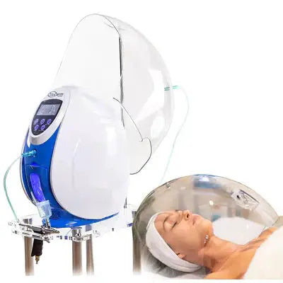 a woman laying in a Oxygen Dome with a machine on top of it