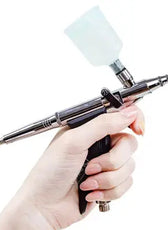 a person holding a small metal object in their hand