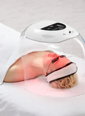 a woman laying on a bed with an oxygen mask