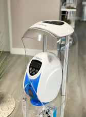 a white and blue machine sitting on top of a wooden floor